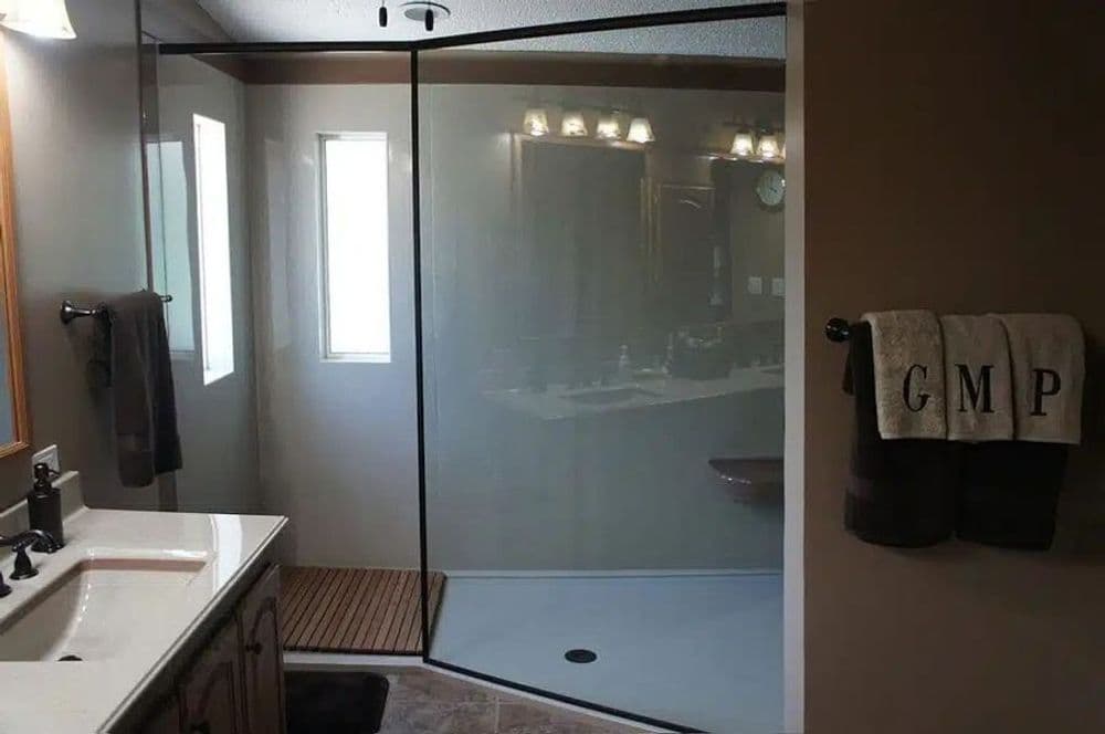 Modern bathroom featuring a glass shower enclosure and stylish fixtures.